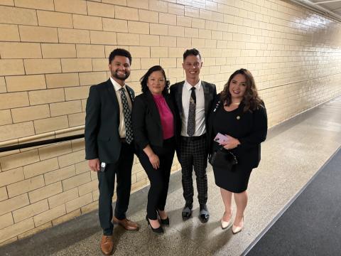 four people standing for picture